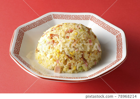 Photographed a single Gomoku fried rice with various ingredients such as Narutomaki and char siu on a red background Photographed a single Gomoku fried rice with various ingredients such as Narutomaki and char siu on a red background 78968214
