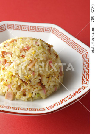 Photographed a single Gomoku fried rice with various ingredients such as Narutomaki and char siu on a red background Photographed a single Gomoku fried rice with various ingredients such as Narutomaki and char siu on a red background 78968226