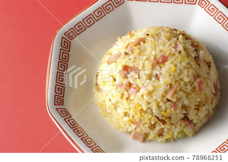 A bird's-eye view of a single Gomoku fried rice with various ingredients such as Narutomaki and char siu on a red background A bird's-eye view of a single Gomoku fried rice with various ingredients such as Narutomaki and char siu on a red background 78968251