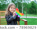 Caucasian little girl playing with pop it silicone trendy rainbow colow toy 78969829