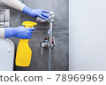 Hands in protective gloves cleaning hygienic shower in sanitary room 78969969
