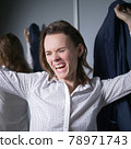 portrait of an emotional business woman taking off her jacket, smiling happily 78971743