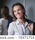 portrait of an emotional business woman taking off her jacket, smiling happily 78971758