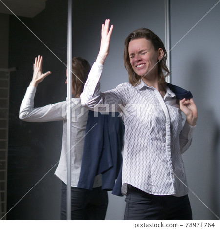 portrait of an emotional business woman taking off her jacket, smiling happily 78971764