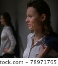 portrait of an emotional business woman taking off her jacket, smiling happily 78971765