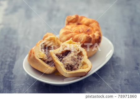typical portuguese and brazilian chicken small pies on white dish 78971860