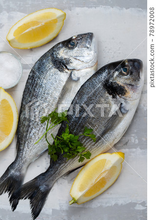 raw fish with olive oil and lemon background raw fish with olive oil and lemon background 78972008