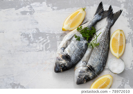 raw fish with olive oil and lemon background raw fish with olive oil and lemon background 78972010