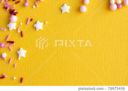 Decorations for pastry on yellow background. Cake decorating Decorations for pastry on yellow background. Cake decorating 78975436