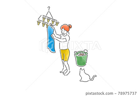 A smiling woman spending a fulfilling day washing clothes A smiling woman spending a fulfilling day washing clothes 78975737