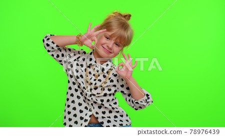 Child kid girl looking approvingly at camera showing ok gesture, like sign positive something good 78976439