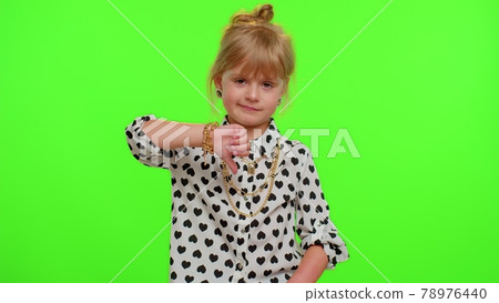Upset kid child girl showing thumbs down sign gesture, expressing discontent, disapproval, dislike 78976440