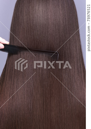 A closeup view of a bunch of shiny straight brown hair A closeup view of a bunch of shiny straight brown hair 78976521