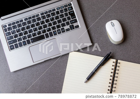 Laptop and writing utensils 78978872