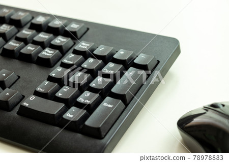 Black keyboard and mouse placed on a white desk Black keyboard and mouse placed on a white desk 78978883