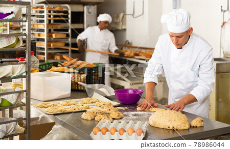 portrait male baker making cookies in bakehouse portrait male baker making cookies in bakehouse 78986044