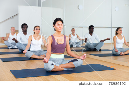Man and woman making yoga meditation in lotus pose in fitness 78986192