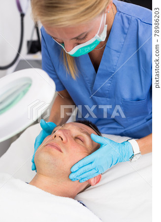 Woman specialist is massaging skin of patient before the procedure 78986203