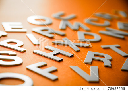 Mixed letters pile close up view. Orange background Mixed letters pile close up view. Orange background 78987366