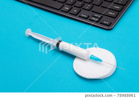 Vaccination or Revaccination Concept - A Medical Syringe on Blue Table 78988061