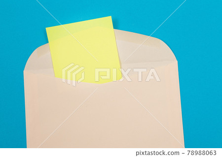 Beige Envelope with Blank Yellow Sheet of Paper Inside 78988063