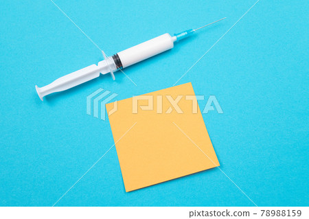 Vaccination or Revaccination Concept - A Medical Syringe on Blue Table Vaccination or Revaccination Concept - A Medical Syringe on Blue Table 78988159