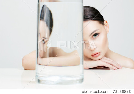 beautiful girl under glass bottle with water beautiful girl under glass bottle with water 78988858