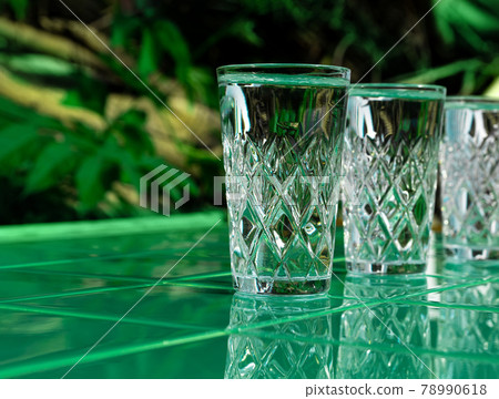 Refreshing summer drinks in crystal glasses on yellow bar tile background with harsh shadows Sweet cold natural cocktail Refreshing summer drinks in crystal glasses on yellow bar tile background with harsh shadows Sweet cold natural cocktail 78990618