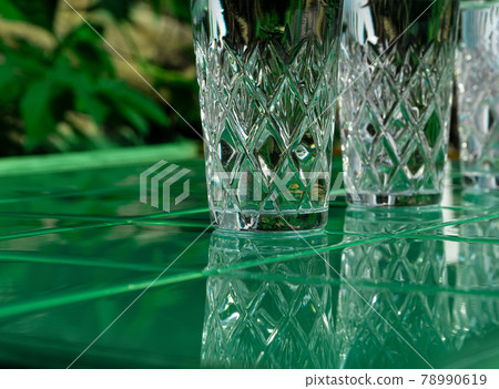 Refreshing summer drinks in crystal glasses on yellow bar tile background with harsh shadows Sweet cold natural cocktail Refreshing summer drinks in crystal glasses on yellow bar tile background with harsh shadows Sweet cold natural cocktail 78990619