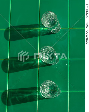 Refreshing summer drinks in crystal glasses on yellow bar tile background with harsh shadows Sweet cold natural cocktail Refreshing summer drinks in crystal glasses on yellow bar tile background with harsh shadows Sweet cold natural cocktail 78990621