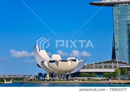 Iconic view of ArtScience museum by Marina Bay Sands, Shoppes mall, Helix bridge, Marina bay on sunny day. Famous landmarks of Singapore city-state.  78992077