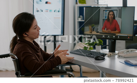 Paralyzed handicapped entrepreneur discussing during video conference Paralyzed handicapped entrepreneur discussing during video conference 78992421
