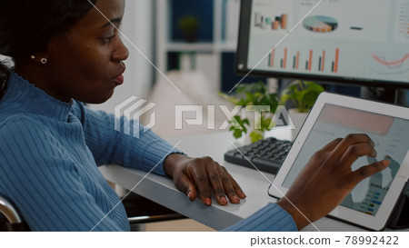 African invalid manager woman using pc and tablet in same time African invalid manager woman using pc and tablet in same time 78992422