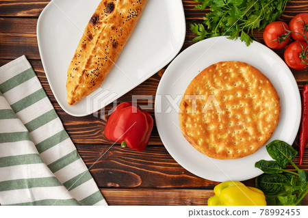 Baked homemade flatbread on wooden background close up 78992455