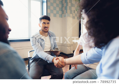 Young people sitting in a circle and having a discussion Young people sitting in a circle and having a discussion 78992735