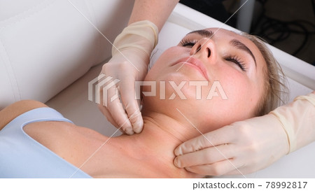 Chin massage of woman young woman during face massage at beauty salon 78992817