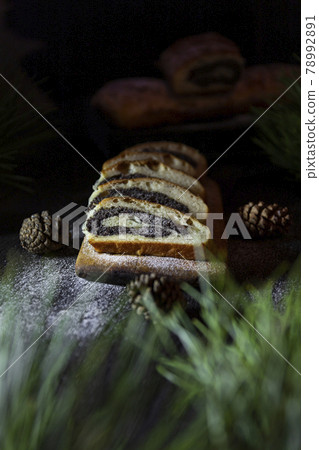 Poppy seed strudel on wooden rustic table. Traditional christmas strudel or Roll cake Poppy seed strudel on wooden rustic table. Traditional christmas strudel or Roll cake 78992891