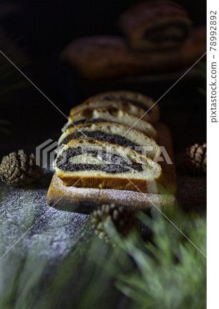 Poppy seed strudel on wooden rustic table. Traditional christmas strudel or Roll cake Poppy seed strudel on wooden rustic table. Traditional christmas strudel or Roll cake 78992892