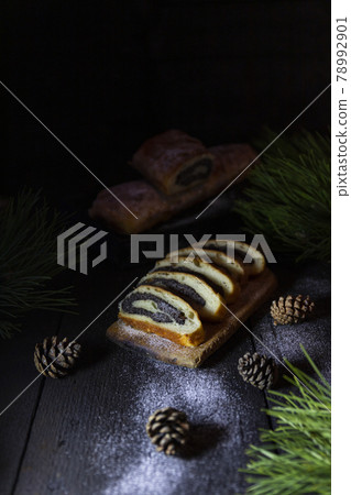 Poppy seed strudel on wooden rustic table. Traditional christmas strudel or Roll cake Poppy seed strudel on wooden rustic table. Traditional christmas strudel or Roll cake 78992901