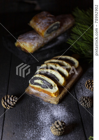 Poppy seed strudel on wooden rustic table. Traditional christmas strudel or Roll cake Poppy seed strudel on wooden rustic table. Traditional christmas strudel or Roll cake 78992902