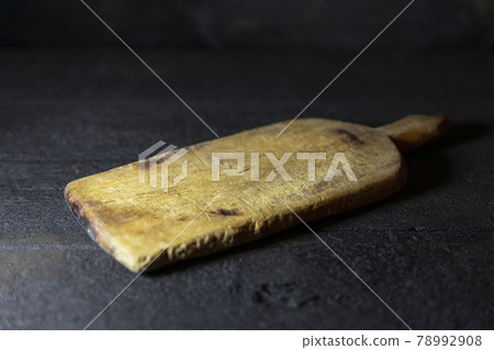 Cutting board on old, rustic wooden table for copy space 78992908