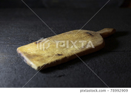 Cutting board on old, rustic wooden table for copy space Cutting board on old, rustic wooden table for copy space 78992909