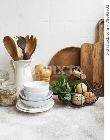 Kitchen utensils, tools and dishware on on the background white tile wall. 78993932