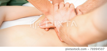 Woman receiving a back massage 78994507