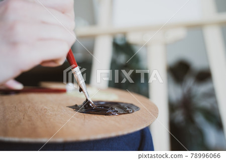 The artist mixes paint with a brush, close-up. Color palette. Learning to draw 78996066