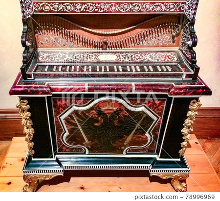 ancient musical instrument, beautiful antique musical instrument with carving and coat of arms in the museum ancient musical instrument, beautiful antique musical instrument with carving and coat of arms in the museum 78996969
