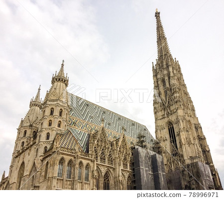 Gothic cathedral, medieval gothic christian cathedral, restoration work, cloudy weather Gothic cathedral, medieval gothic christian cathedral, restoration work, cloudy weather 78996971