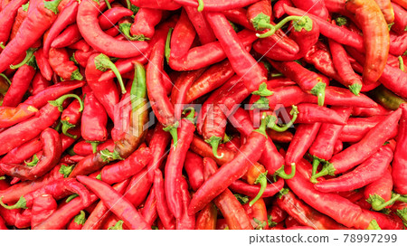 Top view on red pointed peppers displayed in food market Top view on red pointed peppers displayed in food market 78997299