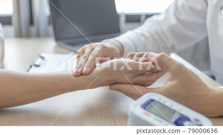 Medical professional measures the pulse of a male patient's wrist to check his heart rate in the hospital's examination room, Doctor checking patient health, Initial symptom check. Medical professional measures the pulse of a male patient's wrist to check his heart rate in the hospital's examination room, Doctor checking patient health, Initial symptom check. 79000636