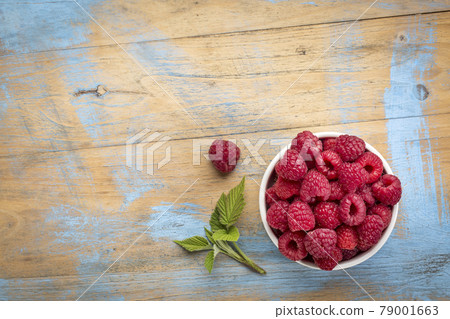 fresh red raspberries with green leaf fresh red raspberries with green leaf 79001663